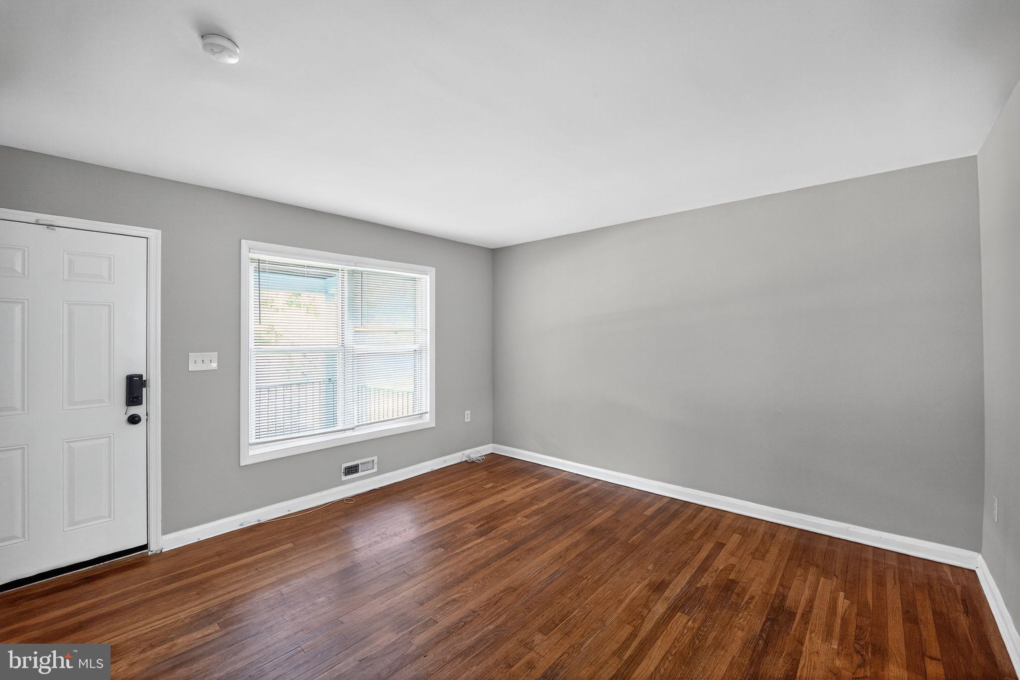 3125 Vulcan Road Dundalk, MD 21222 - Photo 4 of 33 an empty room with wooden floor and windows