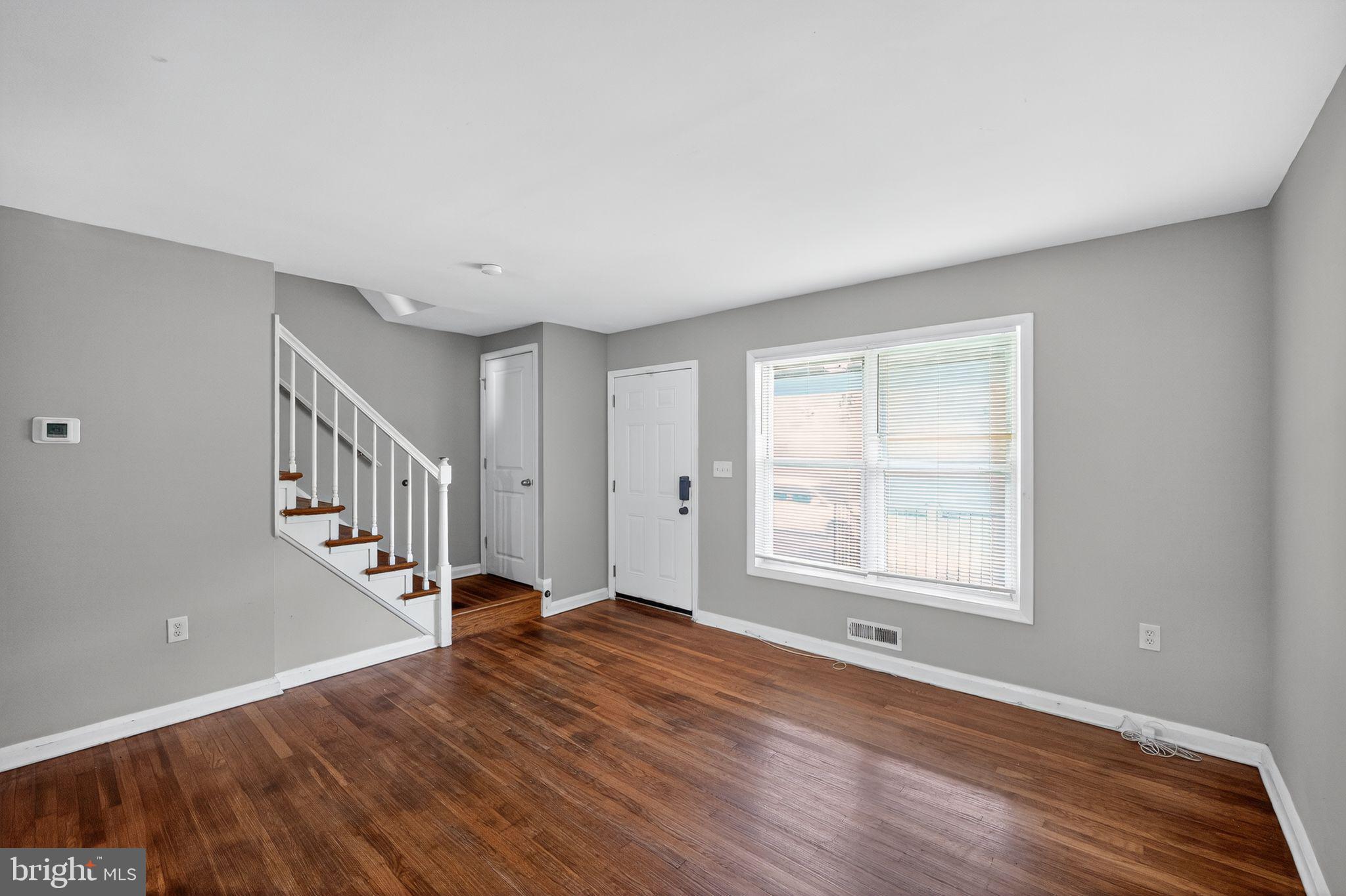 3125 Vulcan Road Dundalk, MD 21222 - Photo 5 of 33 a view of an empty room with wooden floor and a window