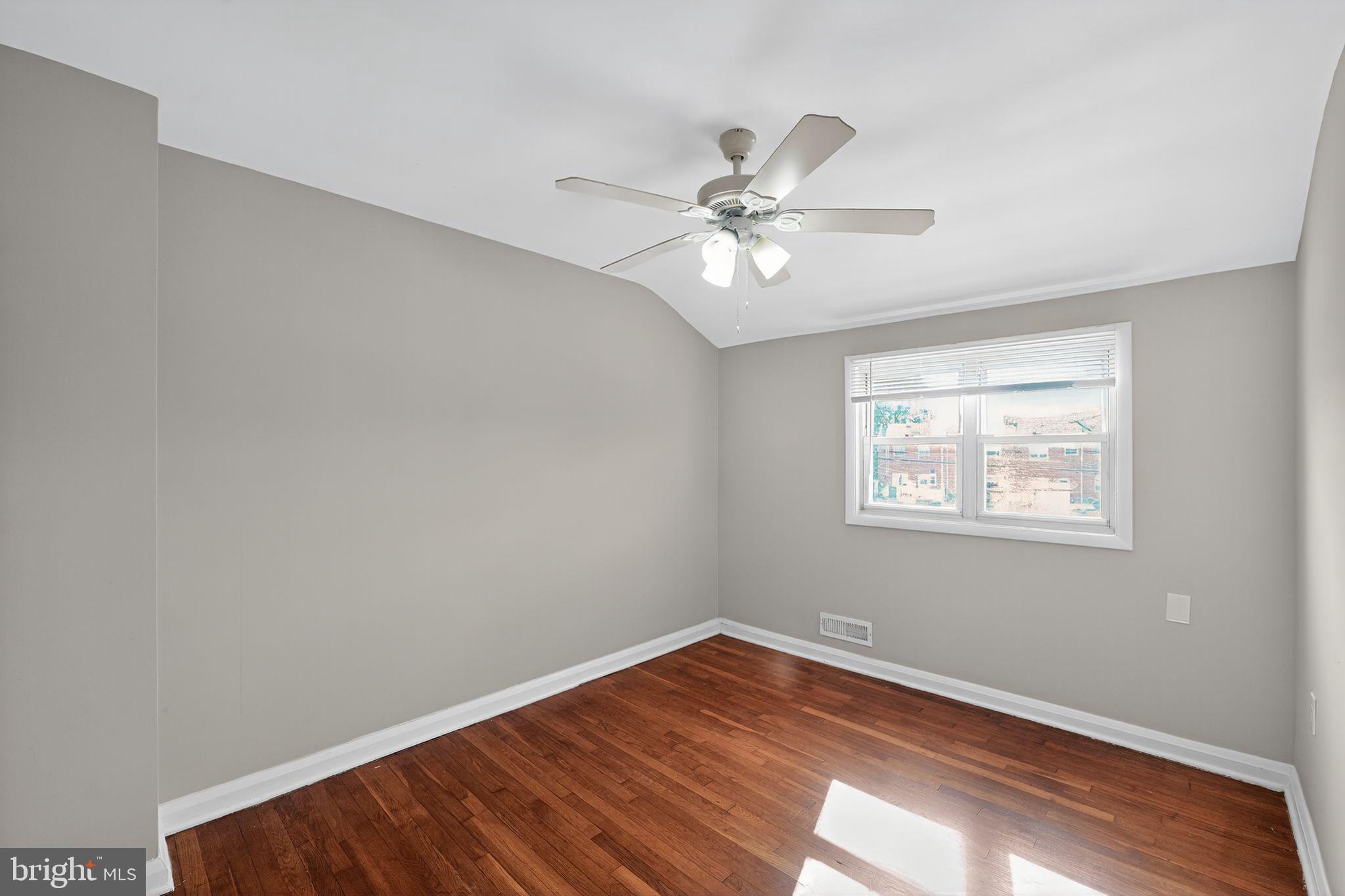 3125 Vulcan Road Dundalk, MD 21222 - Photo 8 of 33 a view of empty room with wooden floor and fan