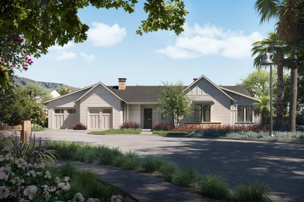 a front view of a house with a garden and trees