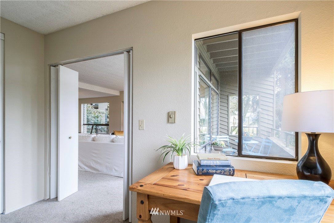 118 Southwest 116th Street, Unit D21 Seattle, WA 98146 - Photo 11 of 17 a bedroom with a bed and a couch next to a window
