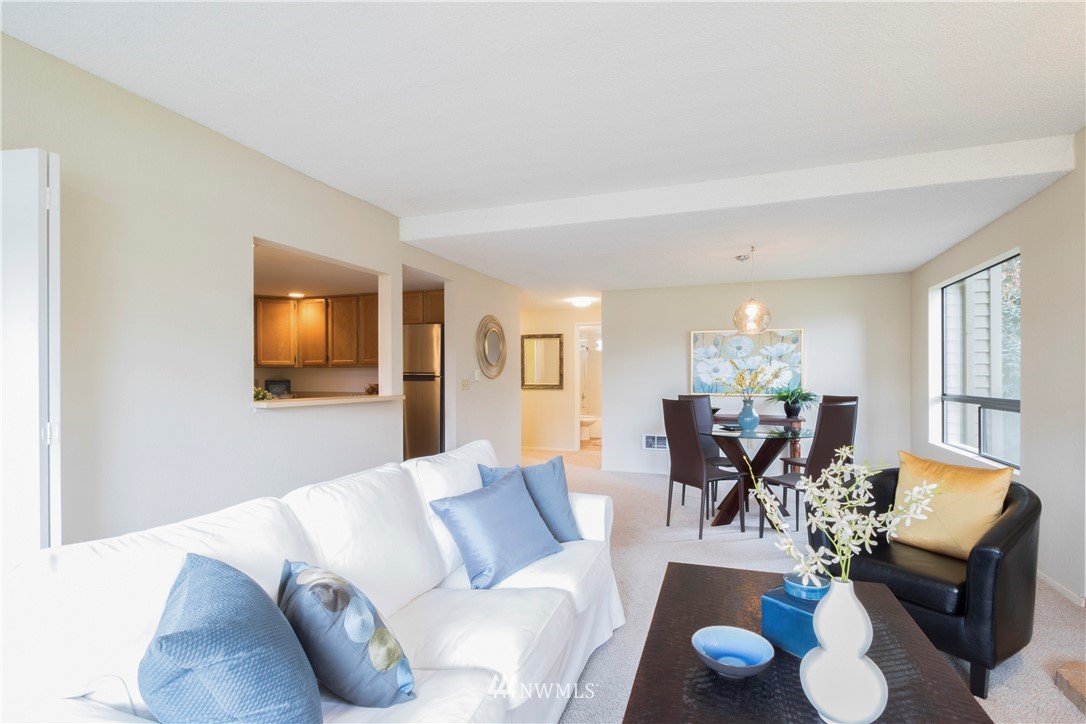 118 Southwest 116th Street, Unit D21 Seattle, WA 98146 - Photo 12 of 17 a living room with furniture and wooden floor