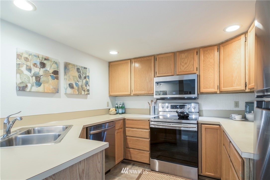 118 Southwest 116th Street, Unit D21 Seattle, WA 98146 - Photo 5 of 17 a kitchen with a sink stove and microwave