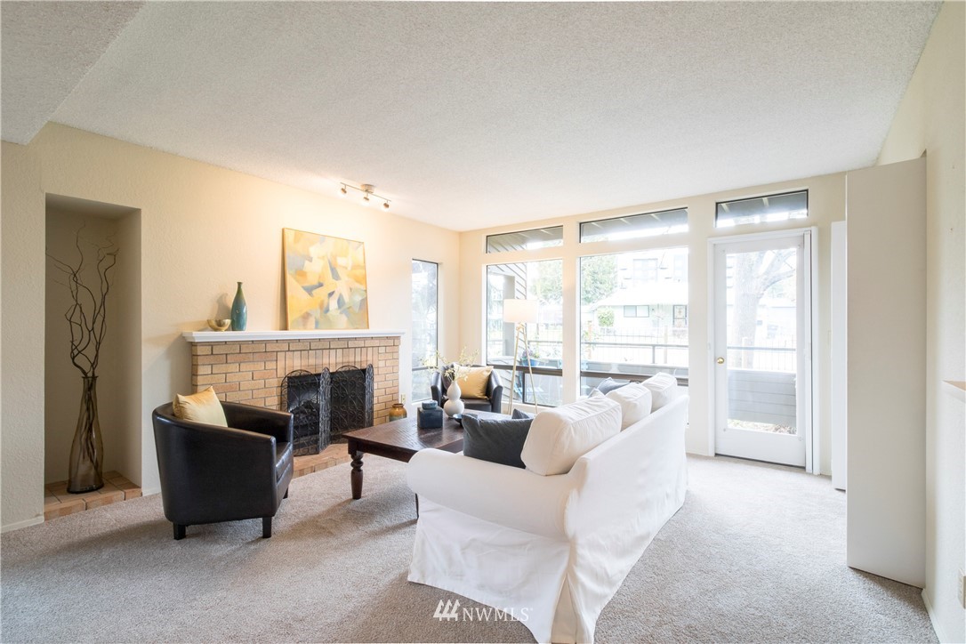 118 Southwest 116th Street, Unit D21 Seattle, WA 98146 - Photo 7 of 17 a living room with furniture a fireplace and a large window