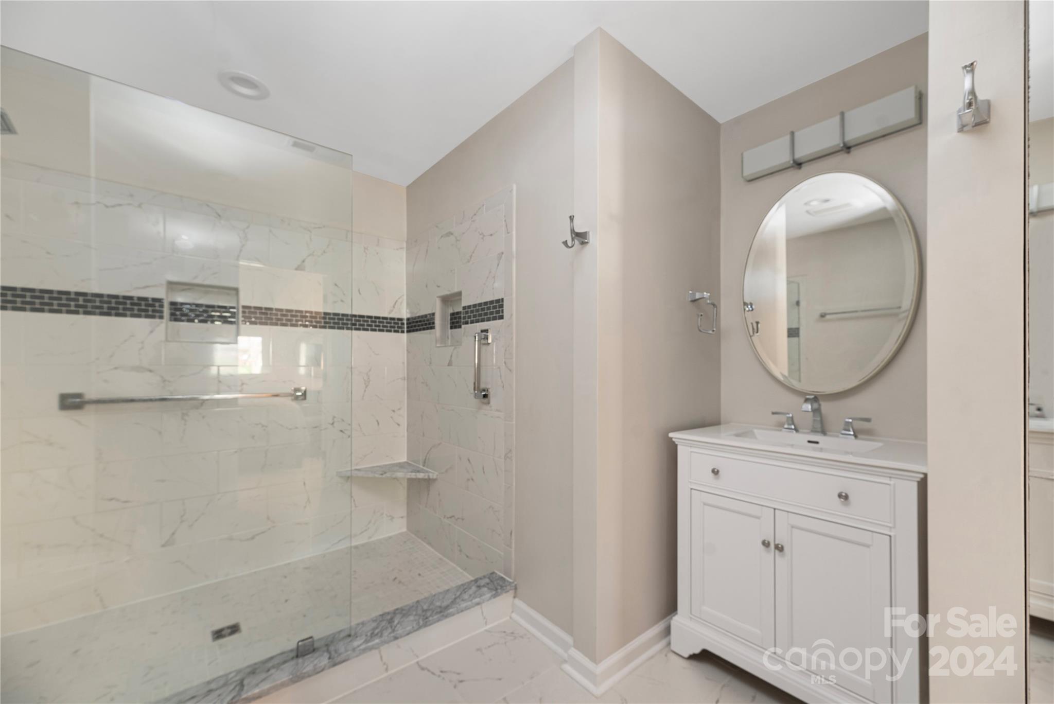 21525 Sandy Cove Road Cornelius, NC 28031 - Photo 19 of 35 a bathroom with a shower a sink and a mirror