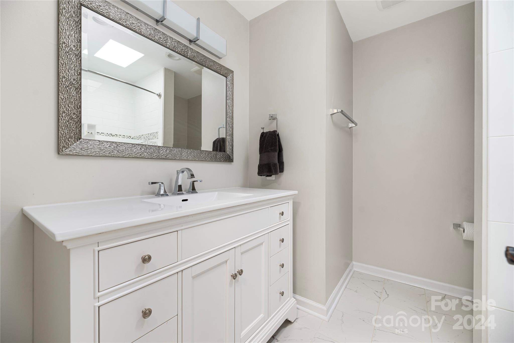21525 Sandy Cove Road Cornelius, NC 28031 - Photo 22 of 35 a bathroom with a sink and a mirror