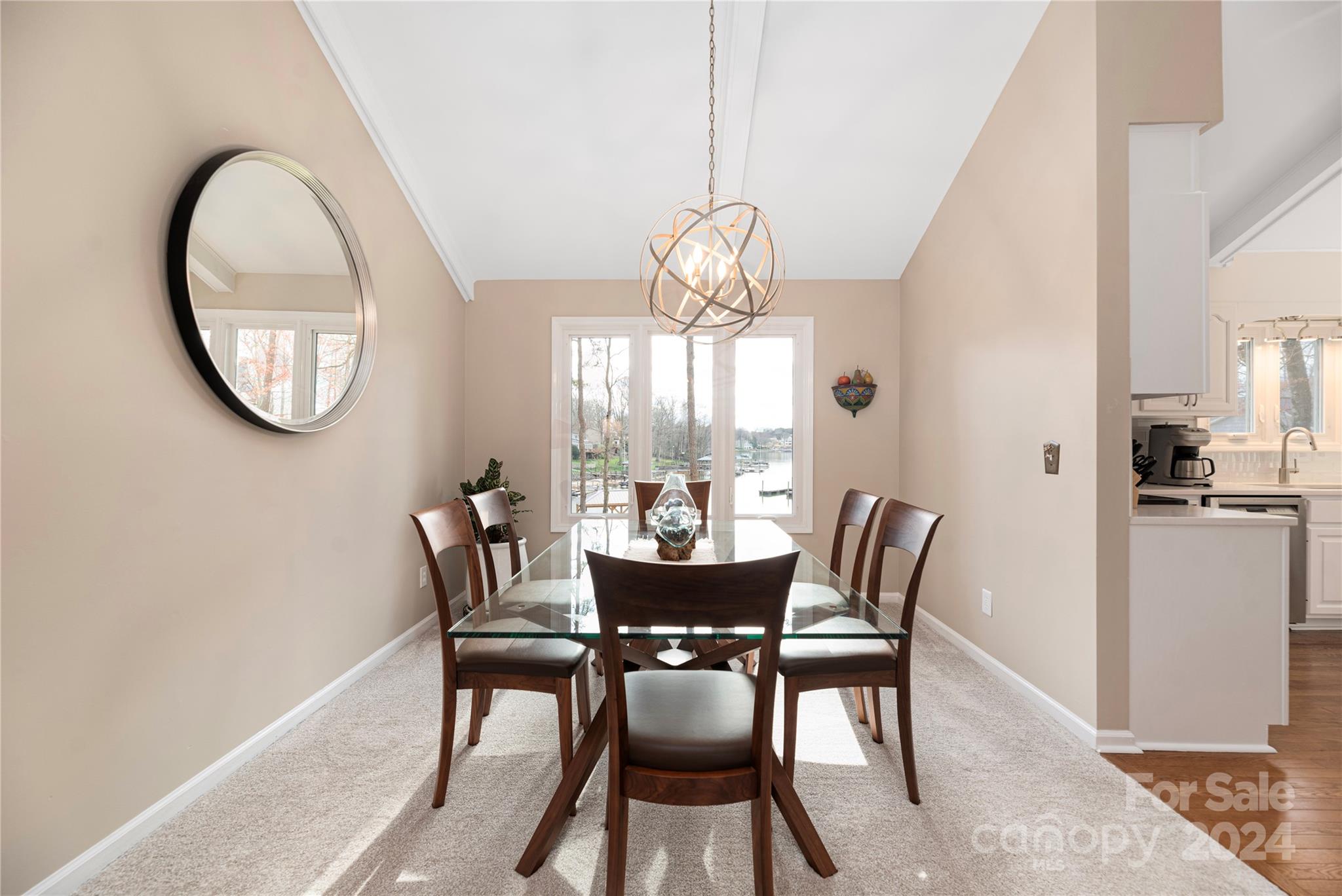 21525 Sandy Cove Road Cornelius, NC 28031 - Photo 9 of 35 a view of a dining room with furniture a chandelier and wooden floor