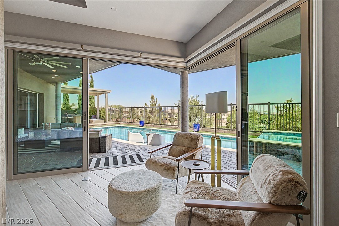 6014 Willow Ridge Court Las Vegas, NV 89135 - Photo 43 of 99 This living space seamlessly connects to the outdoor oasis, offering relaxation and refreshment.