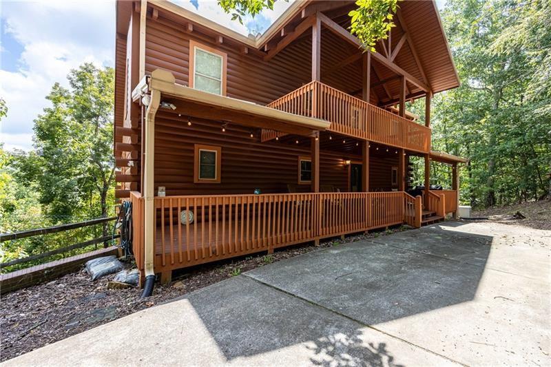 a view of a house with a yard and wooden fence