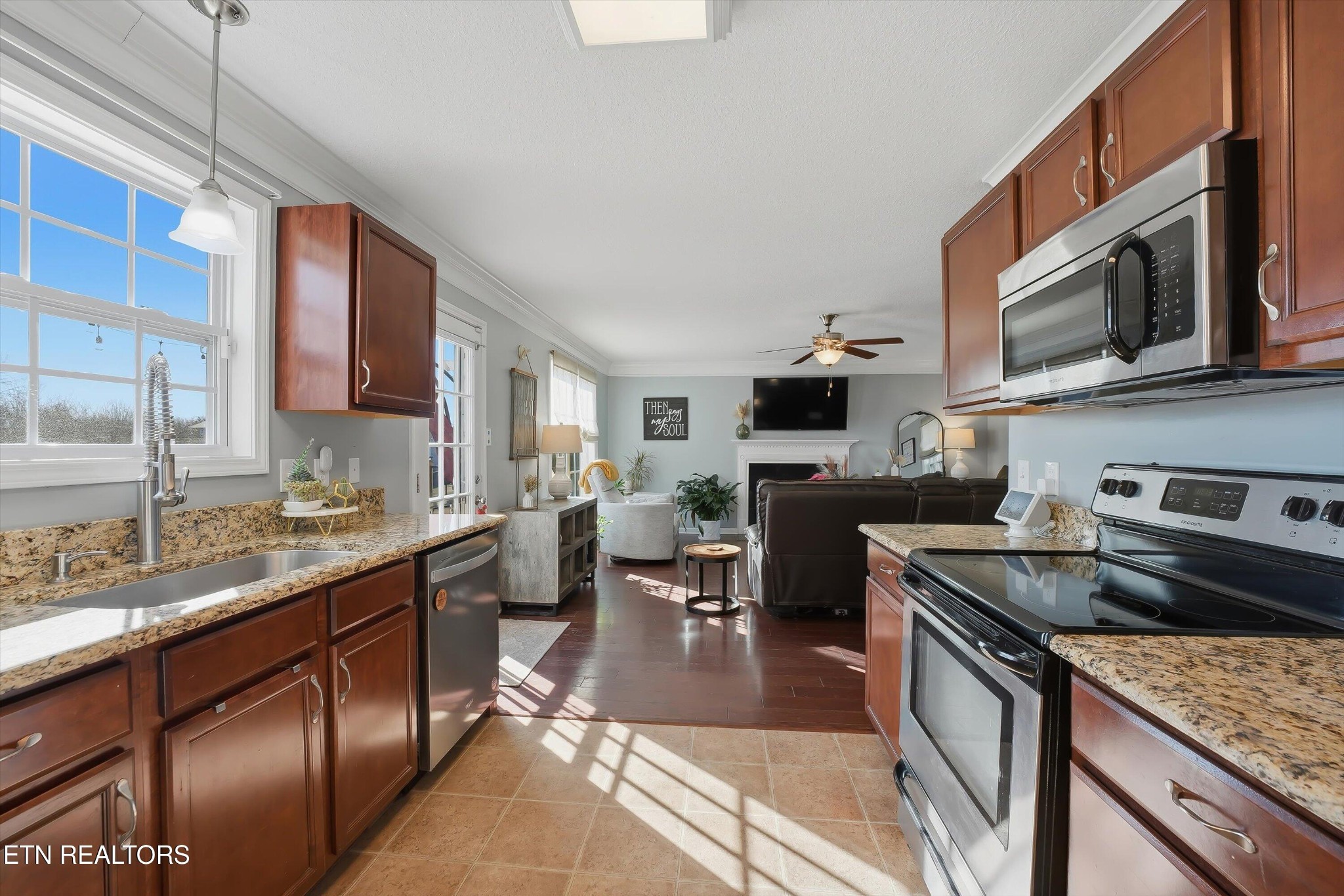 8508 Bowsong Lane Powell, TN 37849 - Photo 7 of 28 a kitchen with stainless steel appliances granite countertop a stove top oven a sink dishwasher a dining table and chairs with wooden floor