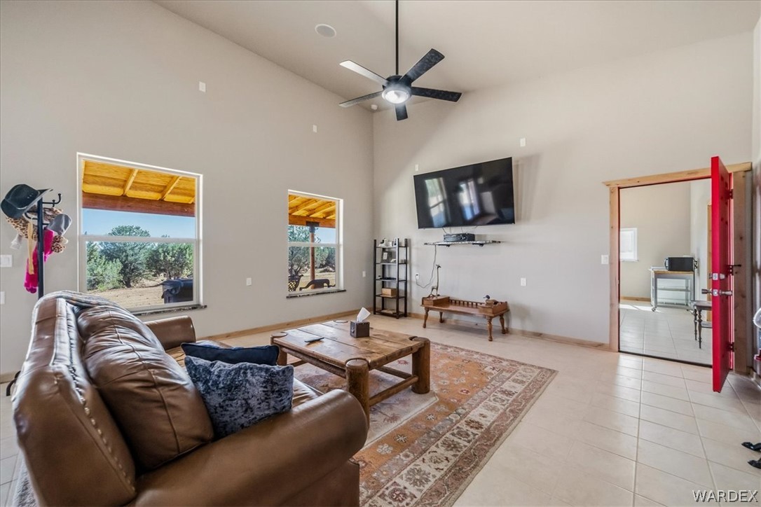 10374 East Happy Trails Road Kingman, AZ 86401 - Photo 13 of 68 a living room with furniture a flat screen tv and a wall painting