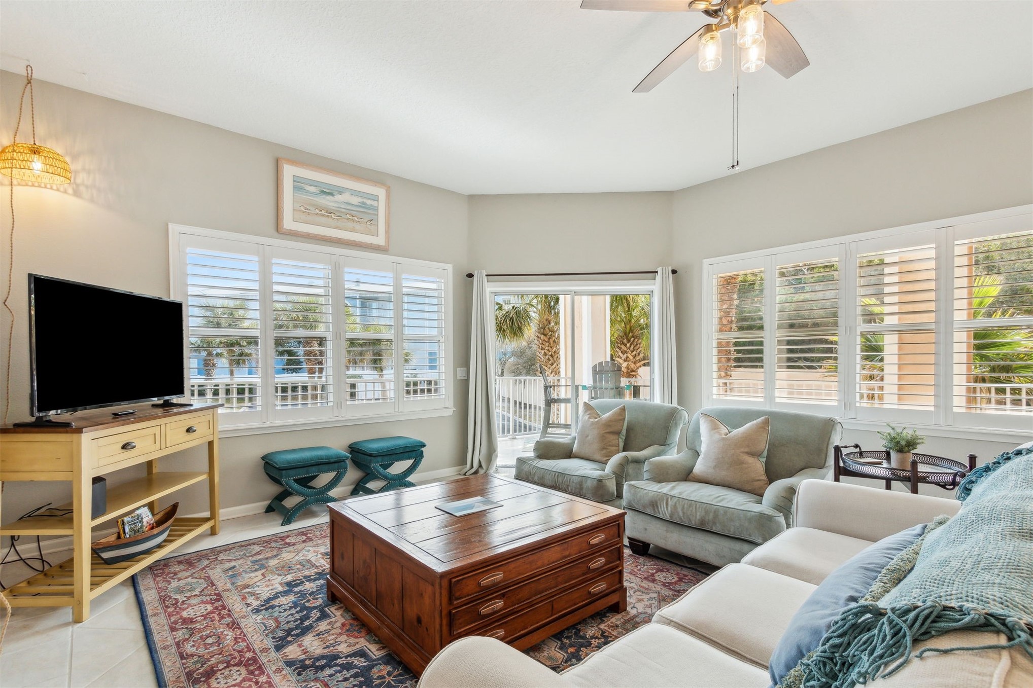 403 Tarpon Avenue, Unit 101 Fernandina Beach, FL 32034 - Photo 2 of 36 a living room with furniture a flat screen tv and a large window