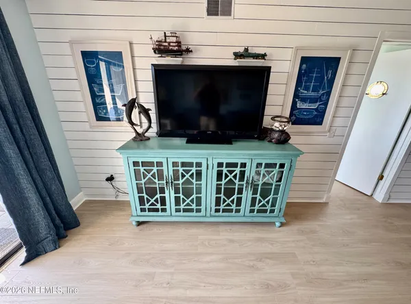 a living room with a fireplace and a flat screen tv