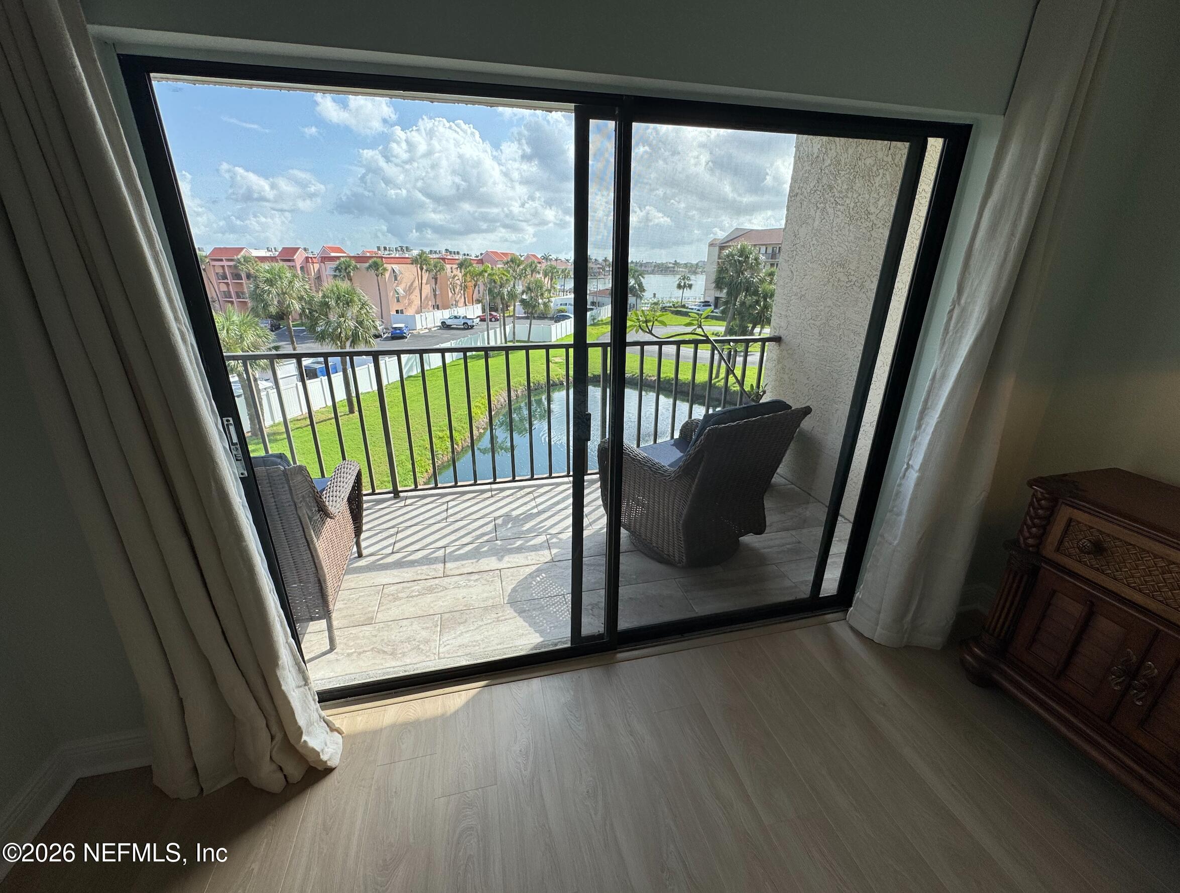 8711 Blind Pass Road, Unit 208A St. Petersburg, FL 33706 - Photo 14 of 21 a view of a balcony with wooden floor