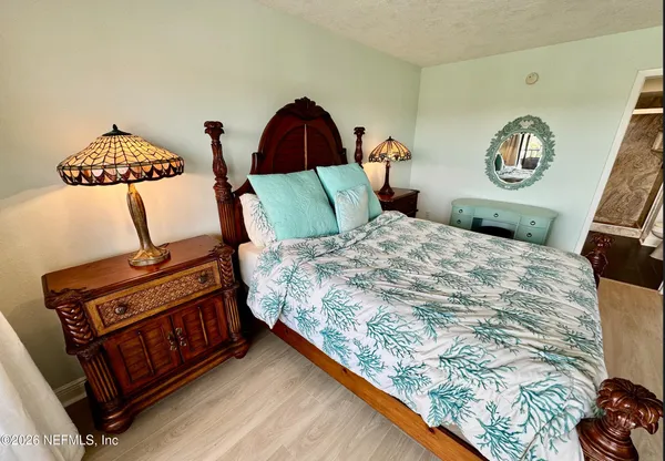 a bed sitting in a bedroom next to a window