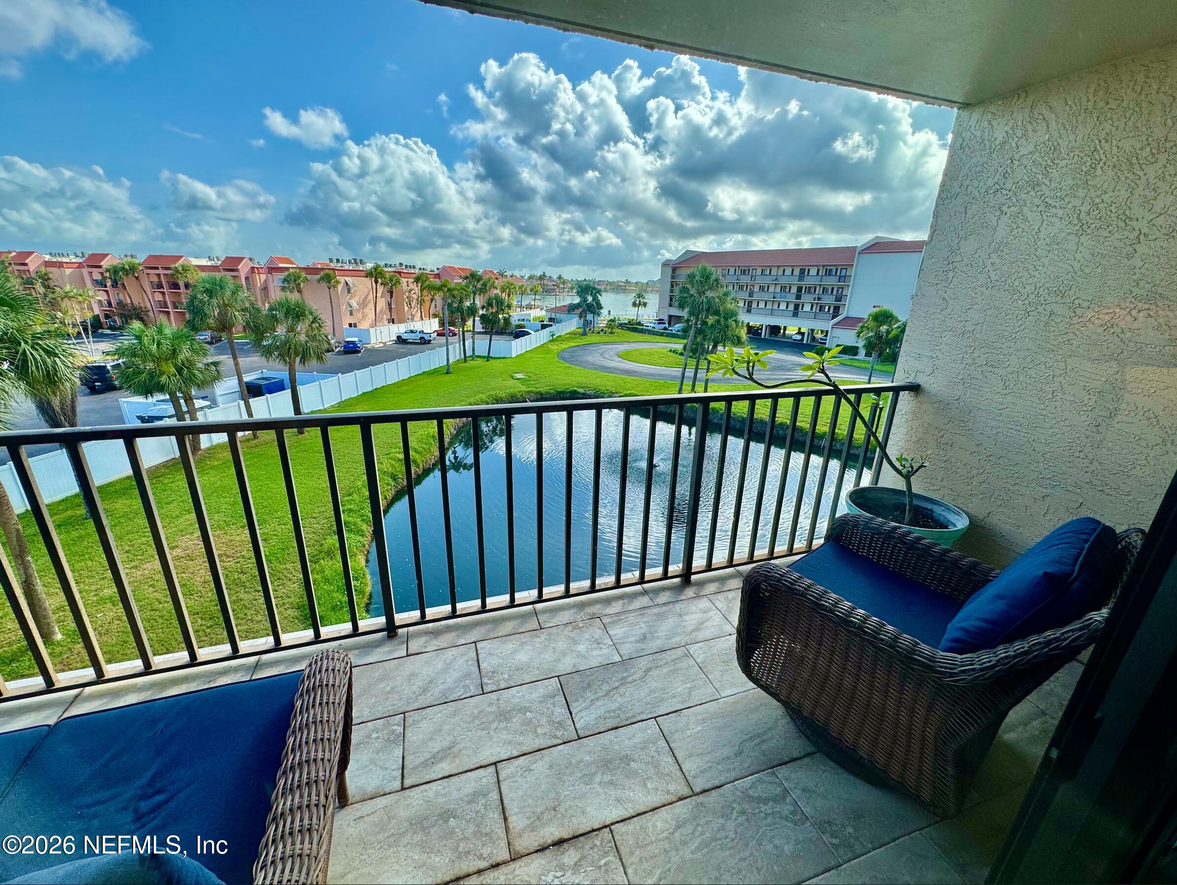 8711 Blind Pass Road, Unit 208A St. Petersburg, FL 33706 - Photo 16 of 21 a view of a porch with furniture
