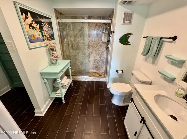 a bathroom with a sink toilet and shower