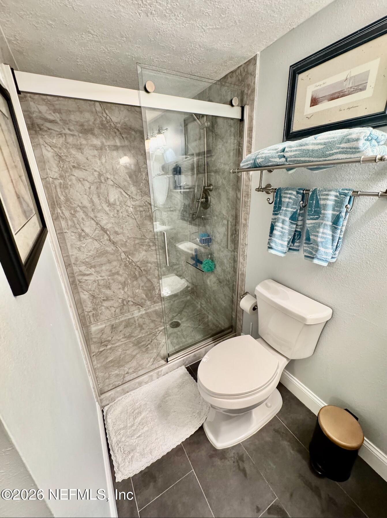 8711 Blind Pass Road, Unit 208A St. Petersburg, FL 33706 - Photo 4 of 21 a bathroom with a toilet and a shower