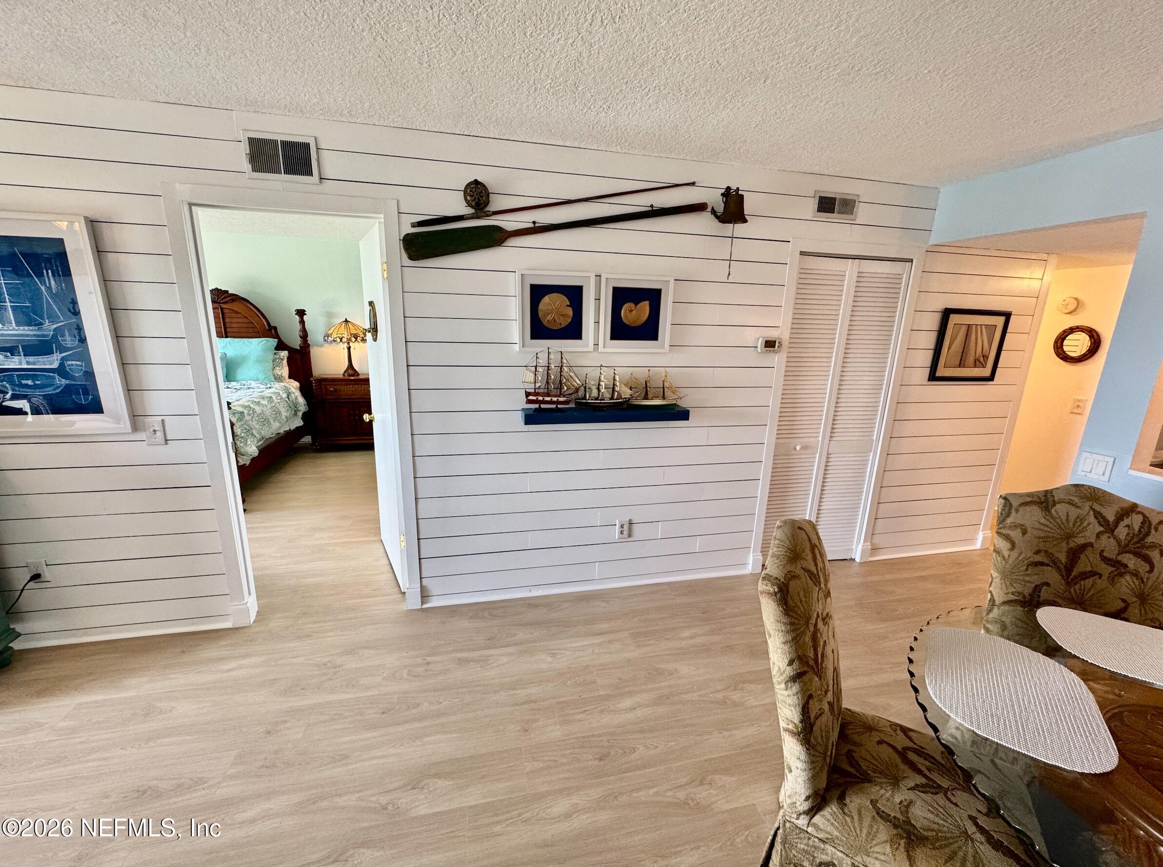 8711 Blind Pass Road, Unit 208A St. Petersburg, FL 33706 - Photo 6 of 21 a bedroom with a bed and a cabinets