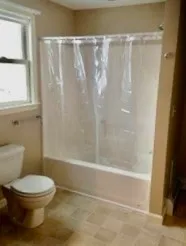 a bathroom with a toilet and a shower