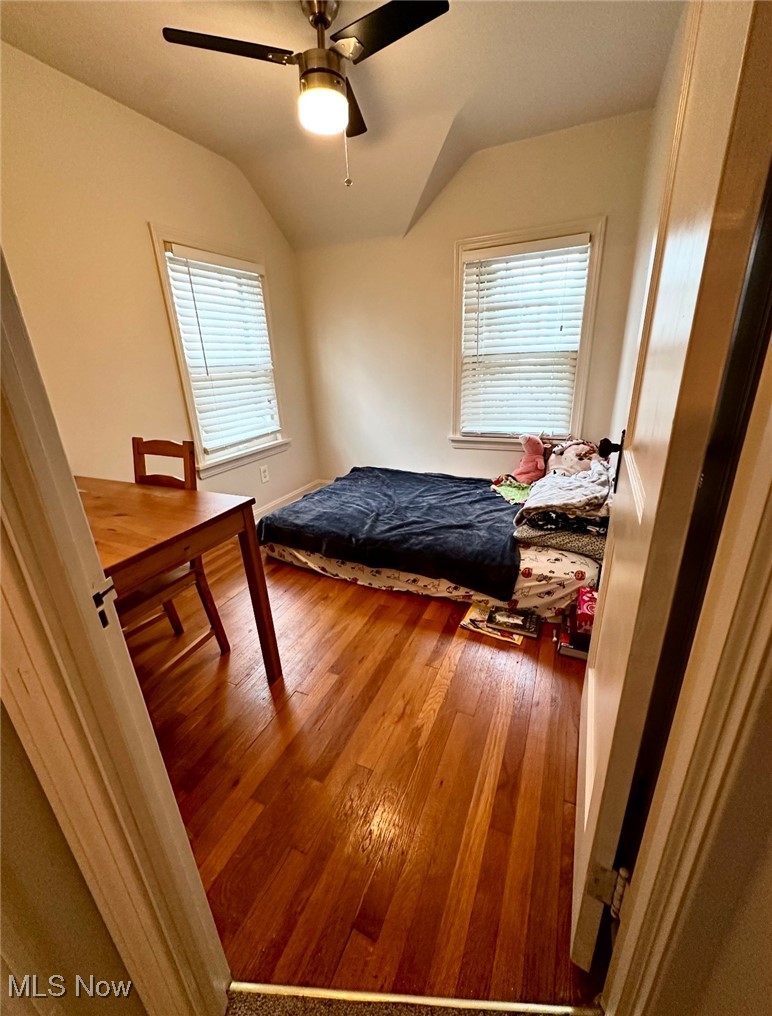 1334 Avondale Road Cleveland, OH 44121 - Photo 9 of 15 Bedroom with ceiling fan, wood-type flooring, multiple windows, and vaulted ceiling