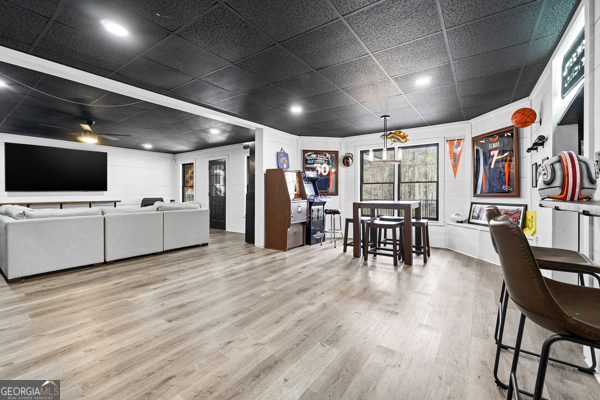 7125 Compton Circle Cumming, GA 30040 - Photo 28 of 40 a living room with lots of furniture and kitchen view