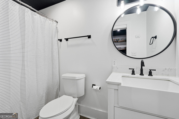 7125 Compton Circle Cumming, GA 30040 - Photo 30 of 40 a bathroom with a sink toilet and a mirror