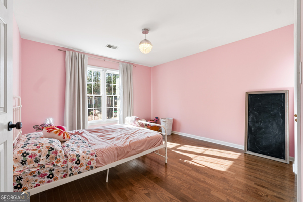 7125 Compton Circle Cumming, GA 30040 - Photo 33 of 40 a bedroom with a bed dresser and a window
