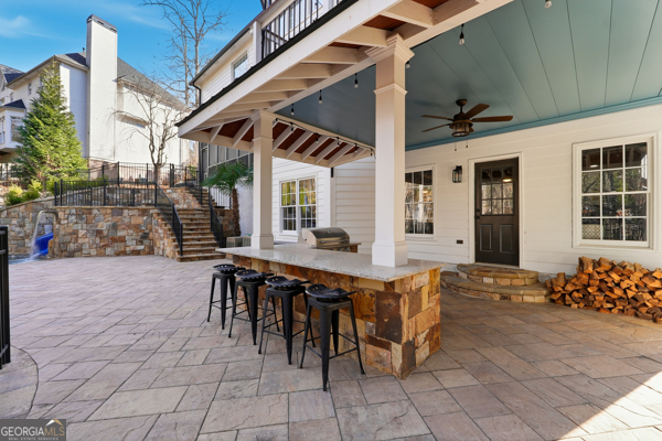 7125 Compton Circle Cumming, GA 30040 - Photo 34 of 40 a view of a patio with table and chairs and potted plants