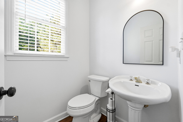 7125 Compton Circle Cumming, GA 30040 - Photo 35 of 40 a bathroom with a sink a toilet and a mirror