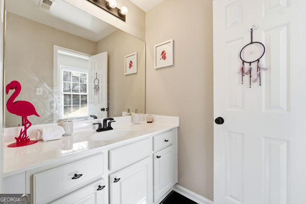 7125 Compton Circle Cumming, GA 30040 - Photo 36 of 40 a bathroom with a sink and a mirror