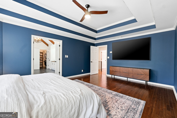 7125 Compton Circle Cumming, GA 30040 - Photo 39 of 40 a bedroom with a bed and a flat tv screen on dresser