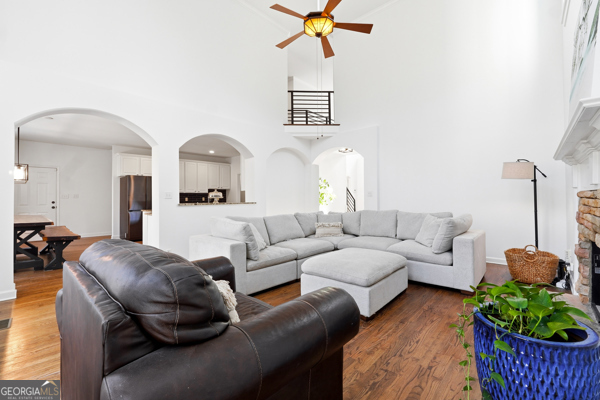 7125 Compton Circle Cumming, GA 30040 - Photo 5 of 40 a living room with furniture a chandelier and a window