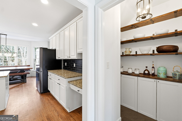 7125 Compton Circle Cumming, GA 30040 - Photo 9 of 40 a kitchen with cabinets and wooden floor