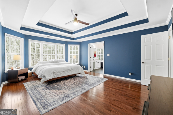 7125 Compton Circle Cumming, GA 30040 - Photo 10 of 40 a spacious bedroom with a large bed and a dresser