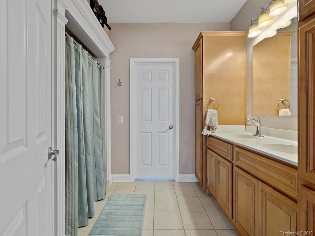 140 Springlake Road York, SC 29745 - Photo 14 of 24 a bathroom with a double vanity sink a mirror and a shower