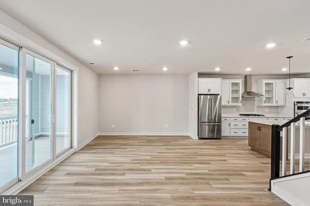 a view of kitchen with stainless steel appliances kitchen island wooden floor and window