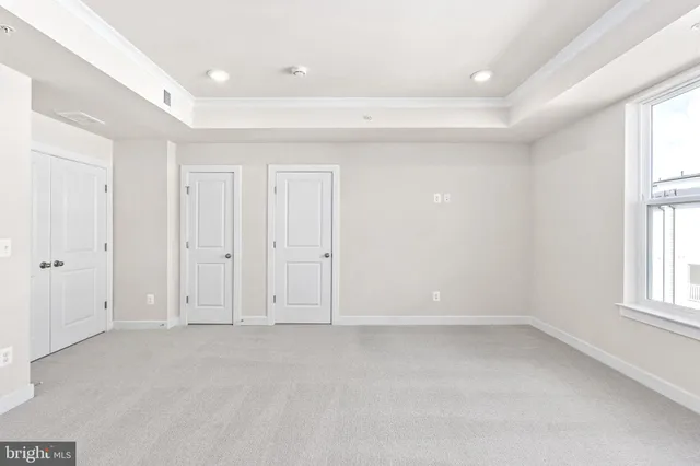 an empty room with windows and closet