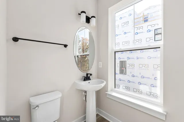 a bathroom with a sink mirror and toilet