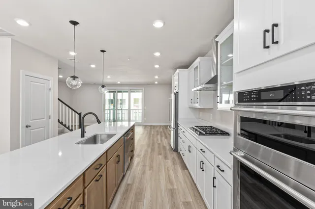 a kitchen with granite countertop a stove and a sink
