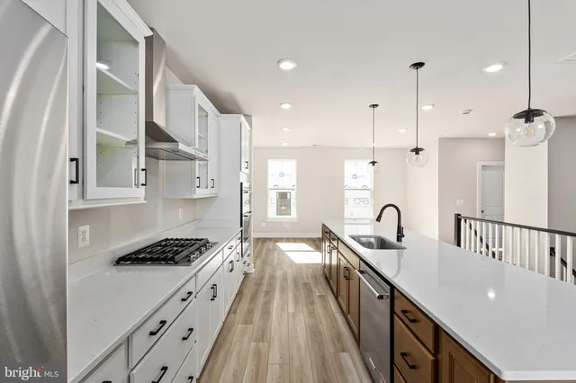 a kitchen with counter top space a sink stainless steel appliances and cabinets
