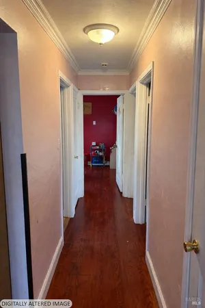 a view of a hallway with wooden floor