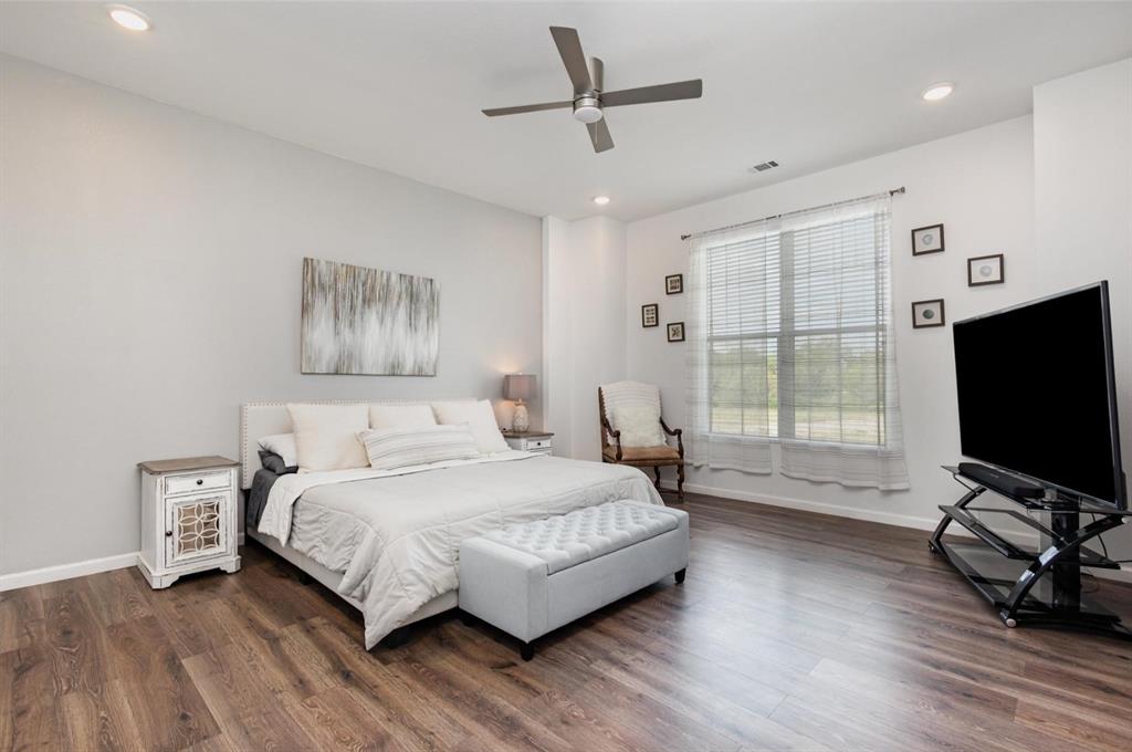 601 Gin Road Ennis, TX 75119 - Photo 15 of 33 a bedroom with a bed and a flat screen tv