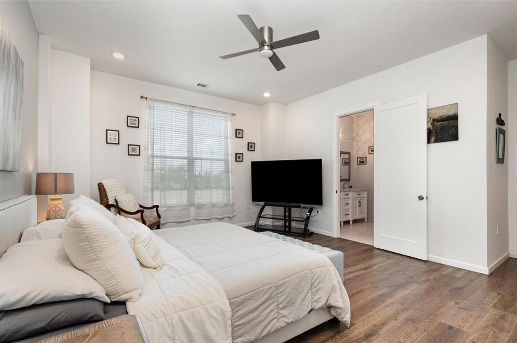 601 Gin Road Ennis, TX 75119 - Photo 16 of 33 a bedroom with a bed and a flat screen tv