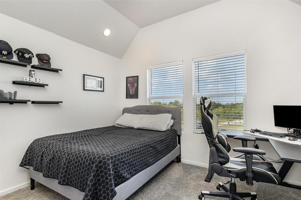601 Gin Road Ennis, TX 75119 - Photo 20 of 33 a bedroom with a bed a desk and chair