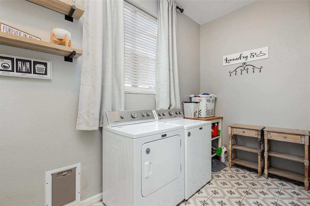 601 Gin Road Ennis, TX 75119 - Photo 22 of 33 a utility room with a sink a cabinetry and a window