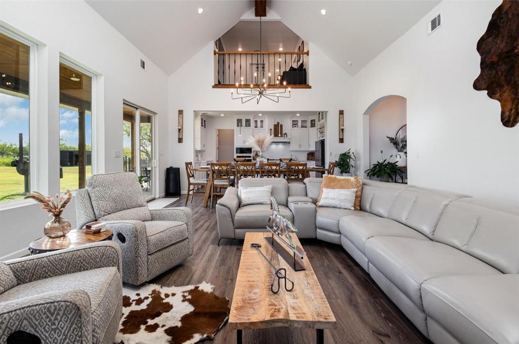 601 Gin Road Ennis, TX 75119 - Photo 6 of 33 a living room with furniture a chandelier and a large window