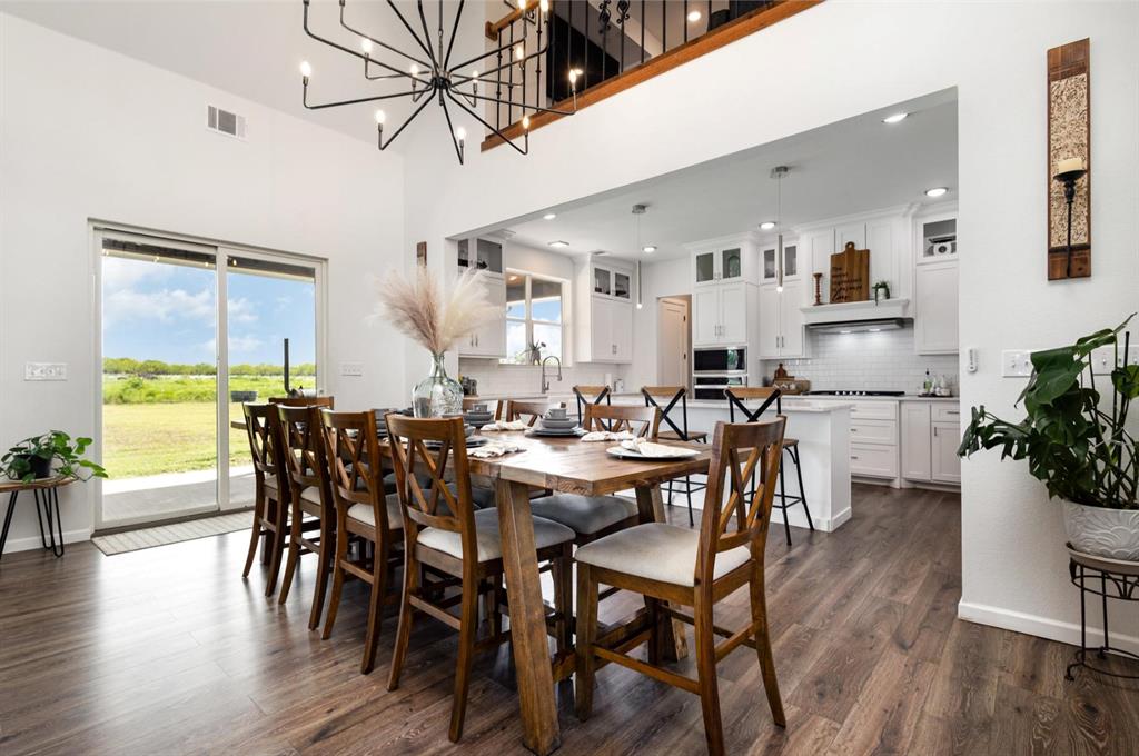 601 Gin Road Ennis, TX 75119 - Photo 8 of 33 a view of a dining room with furniture and wooden floor