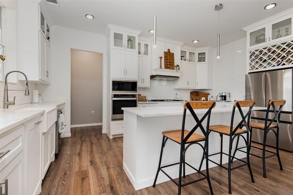 601 Gin Road Ennis, TX 75119 - Photo 10 of 33 a kitchen with stainless steel appliances a white table chairs refrigerator and sink