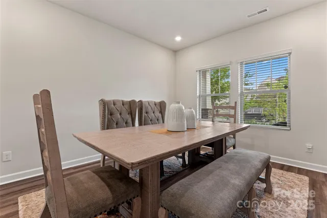 a view of a dining room with furniture and a window